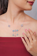 Silver necklace with aqua and pink beaded rhombus charms, a centre trio and three dangling drops