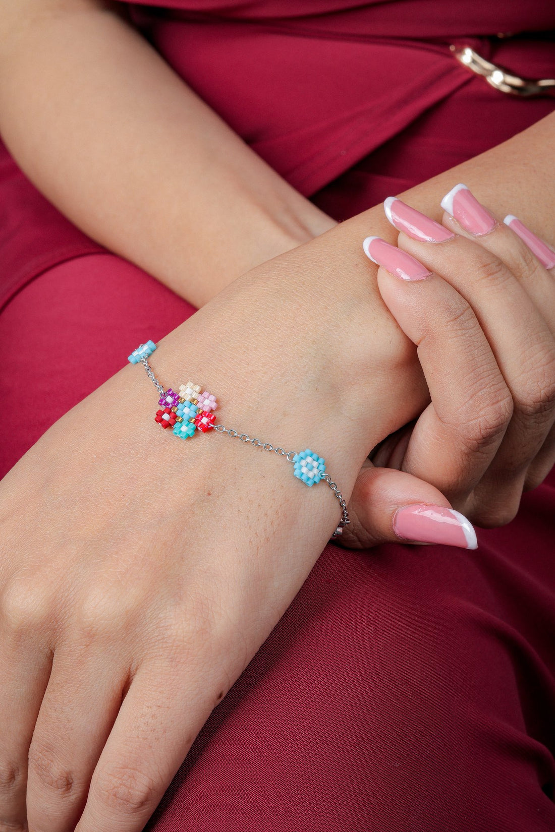 Silver tone chain bracelet with a multicolour beaded flower cluster and sky-blue flower stations