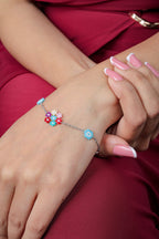 Silver-tone chain bracelet with a multicolour beaded flower cluster and sky-blue flower stations