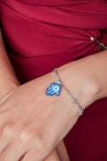 Silver-tone chain bracelet with a blue beaded hamsa charm and small crystal drops