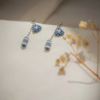 Matching earrings: silver ball studs with blue beaded triangles and dangling beaded tubes