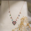 Rose-gold necklace with beaded heart pendant, butterfly charms and coloured crystal drops on cream silk