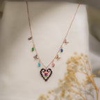 Rose-gold necklace with beaded heart pendant, butterfly charms and coloured crystal drops on cream silk