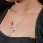 Model wearing the beaded bottle and crystal glass charm necklace over a black top