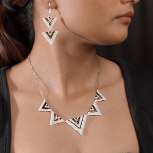 Model wearing chevron triangle necklace with matching double-triangle drop earrings