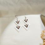 Pair of double-triangle beaded drop earrings in white and brown on silver hooks