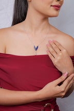 Side view of model wearing a cobalt beaded chevron pendant necklace