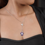 Side view of model wearing silver lariat with pearly fan and cobalt beaded drop
