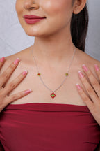 Model smiling in a red top wearing the red diamond beaded pendant necklace