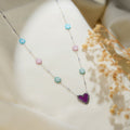 Silver bar-link necklace with turquoise, pink and mint beaded daisies and a purple heart on cream silk