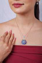 Layered evil-eye and cobalt mandala necklace on a model, hand resting at the chest