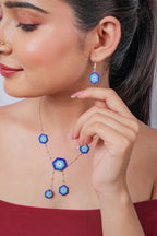 Close view of hexagon evil eye drop earring and Y-shaped necklace with two dangling eyes