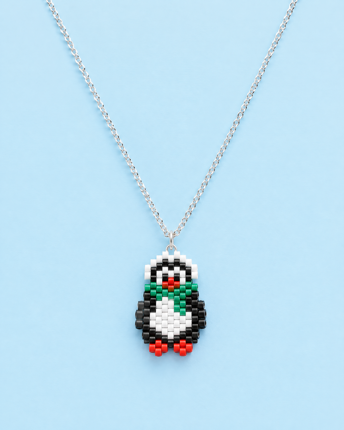 Penguin Pendant on blue background