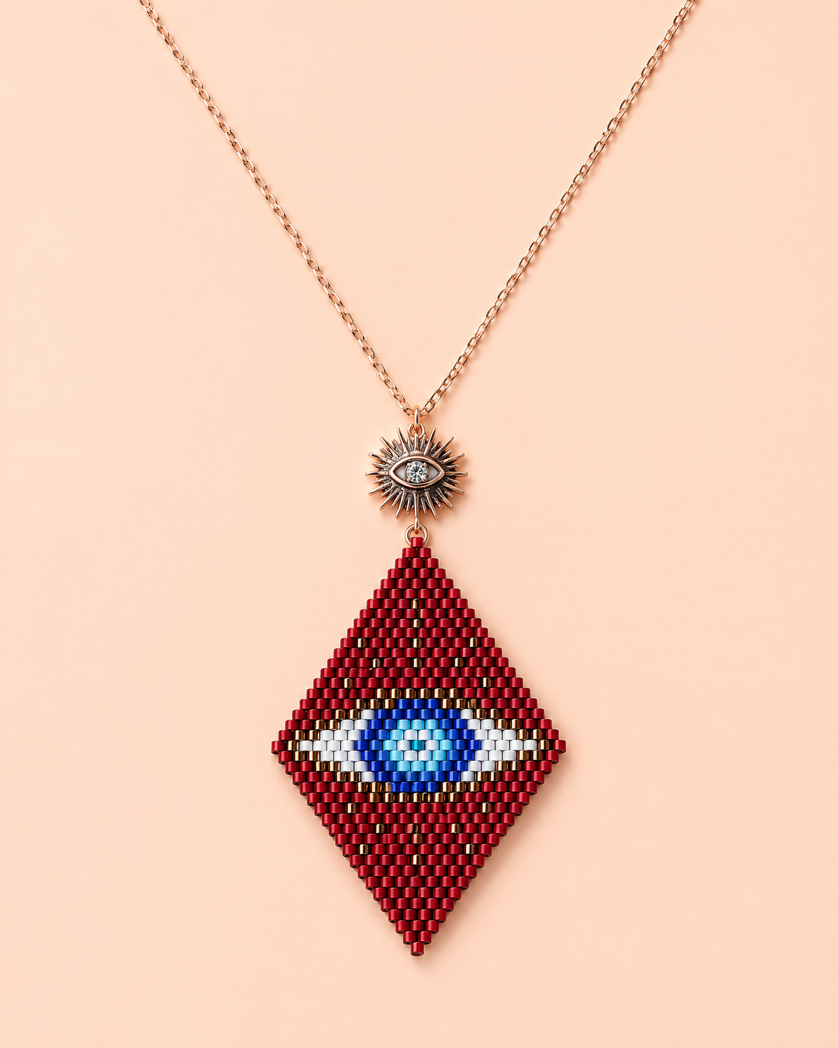 Crimson Evil Eye Pendant on peach background
