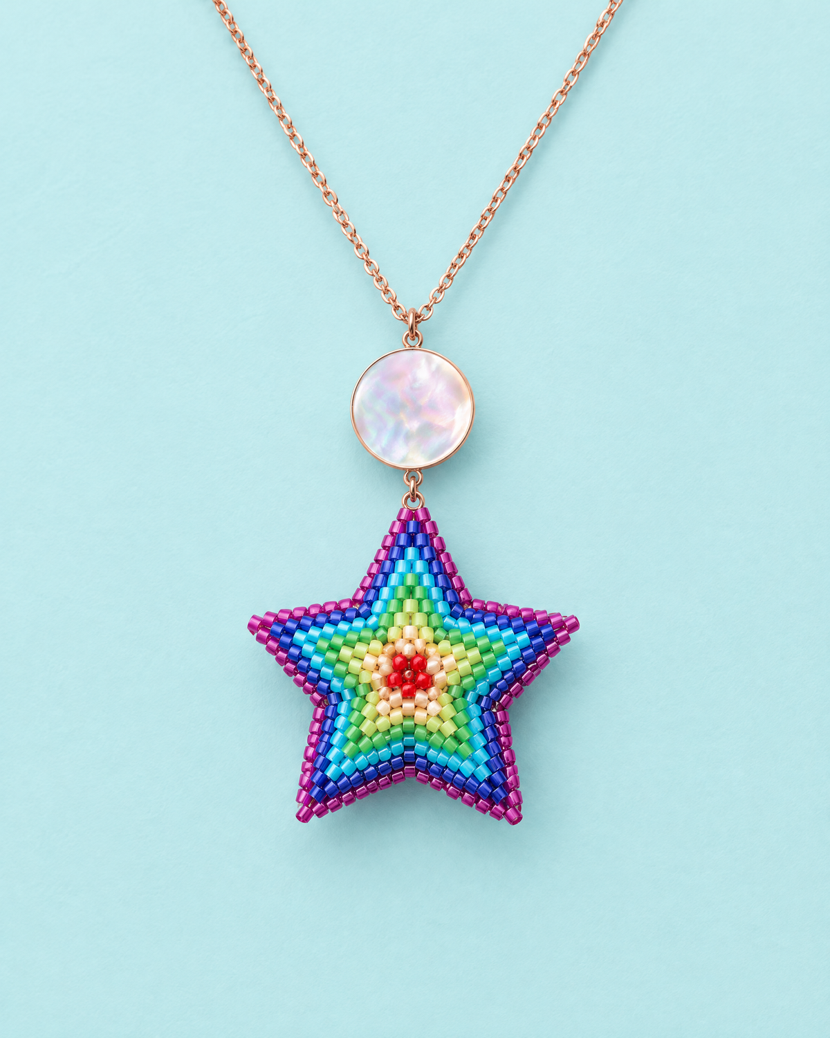 Rainbow Star Pendant on aqua background