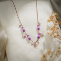 Rose-gold-tone ball chain necklace with purple beaded tubes and crystal butterfly charms