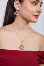 Profile view of model wearing the lilac triangle earrings and pendant necklace set