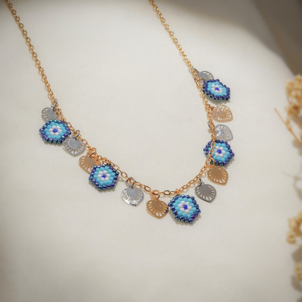 Gold-tone chain with five blue beaded evil-eye charms and silver and gold heart charms