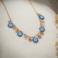 Gold-tone chain with five blue beaded evil-eye charms and silver and gold heart charms