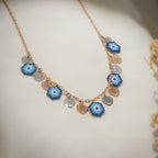 Gold-tone chain with five blue beaded evil-eye charms and silver and gold heart charms
