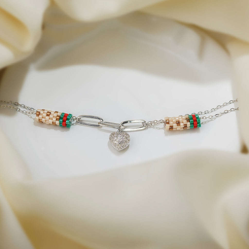 Silver double-chain bracelet with paperclip links, crystal puffed heart charm and striped bead tubes