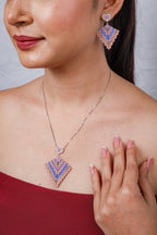 Side view of beaded kite pendant with pink heart connector and matching earring on the model