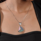 Pink, blue and turquoise triangle pendant on a fine box chain, worn with a black top