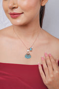 Rose-gold necklace with turquoise beaded seashell, pearly shell charm, beaded fish and crystal fish